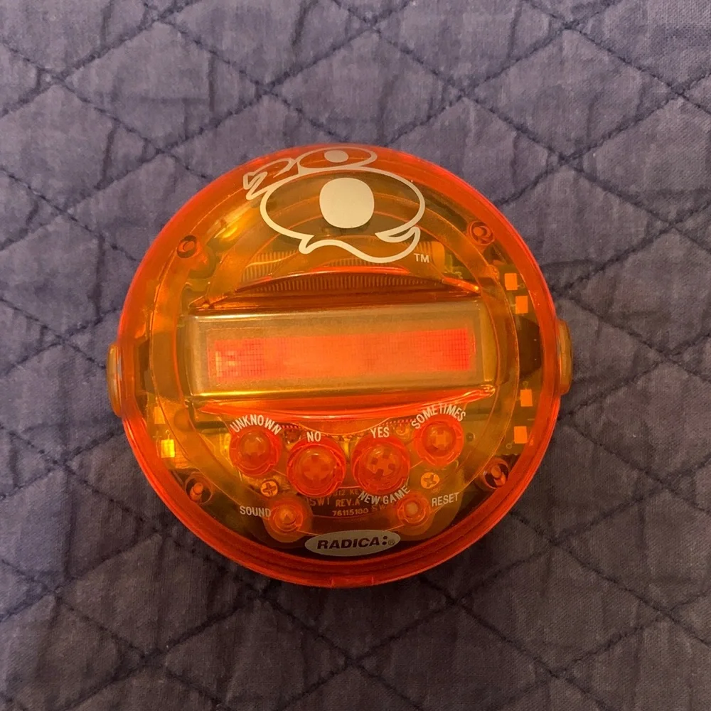 Radica Orange Handheld Electronic Game. 20 questions
